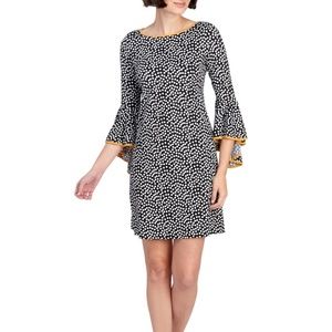 Trimmed with piping along the dramatic bell sleeve